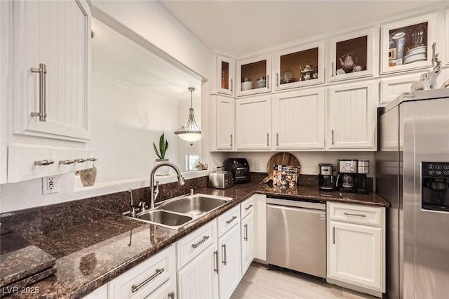 2050 W Warm Springs Rd Unit 3624, Henderson, NV 89014 - kitchen featuring appliances with stainless steel finishes, white cabinets, glass insert cabinets, dark stone countertops, and decorative light fixtures