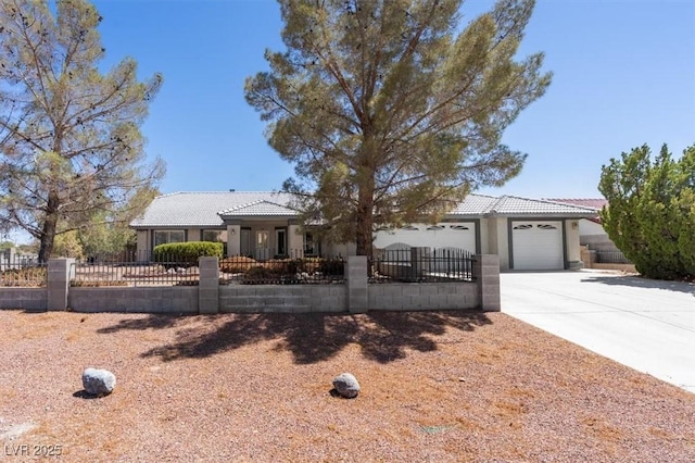 5981 Doubletree Rd, Pahrump, NV 89061 - ranch-style house featuring concrete driveway, a fenced front yard, a garage, a tile roof, and stucco siding