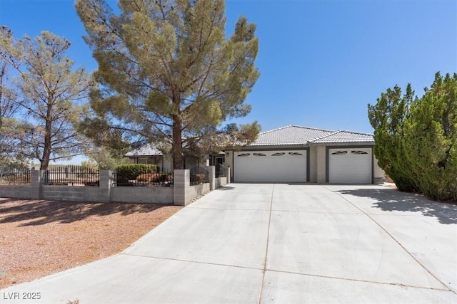5981 Doubletree Rd, Pahrump, NV 89061 - ranch-style house with an attached garage, a fenced front yard, concrete driveway, a tile roof, and stucco siding