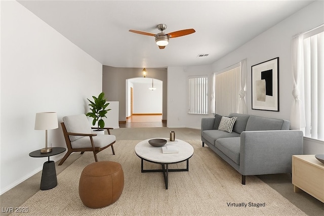 5981 Doubletree Rd, Pahrump, NV 89061 - living area with ceiling fan, light colored carpet, arched walkways, and healthy amount of natural light