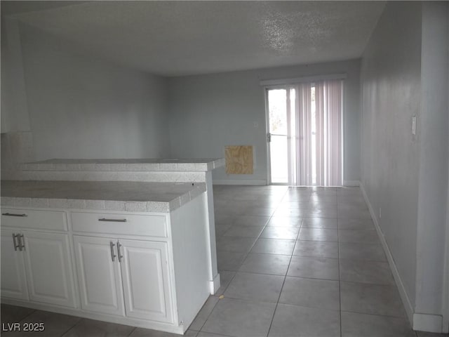 5388 Swenson St Unit 26, Las Vegas, NV 89119 - hallway featuring light tile patterned floors and a textured ceiling