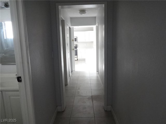 5388 Swenson St Unit 26, Las Vegas, NV 89119 - hall with baseboards and tile patterned flooring