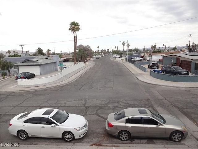 5388 Swenson St Unit 26, Las Vegas, NV 89119 - view of asphalt street featuring sidewalks, a residential view, curbs, and street lighting