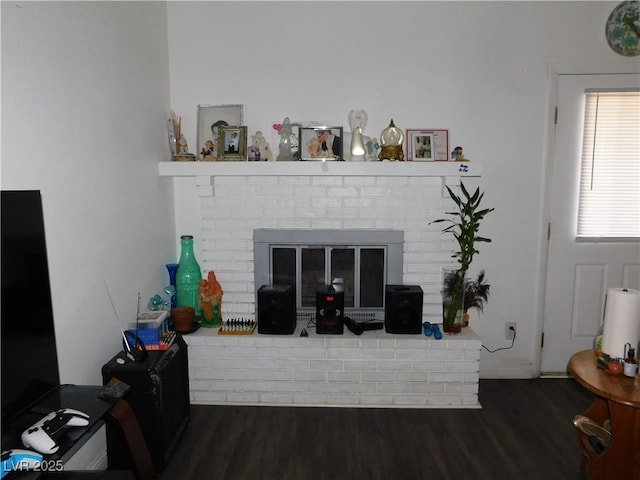 2921 Country Manor Ln Unit 139, Las Vegas, NV 89115 - living room featuring a brick fireplace and wood finished floors