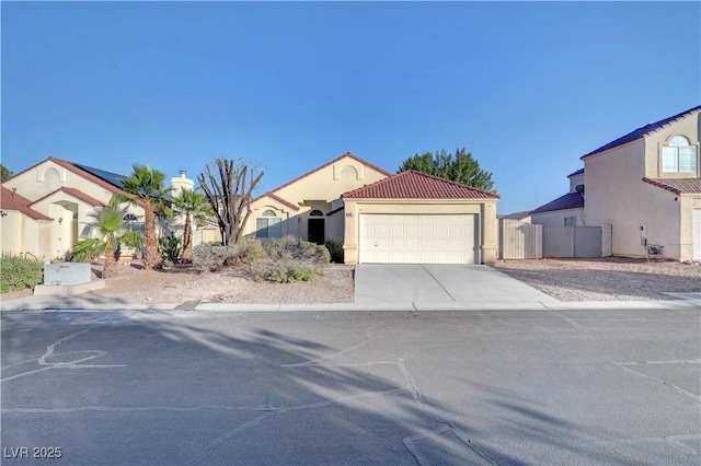641 Bay Bridge Dr, North Las Vegas, NV 89032 - mediterranean / spanish home with an attached garage, driveway, a tiled roof, and stucco siding