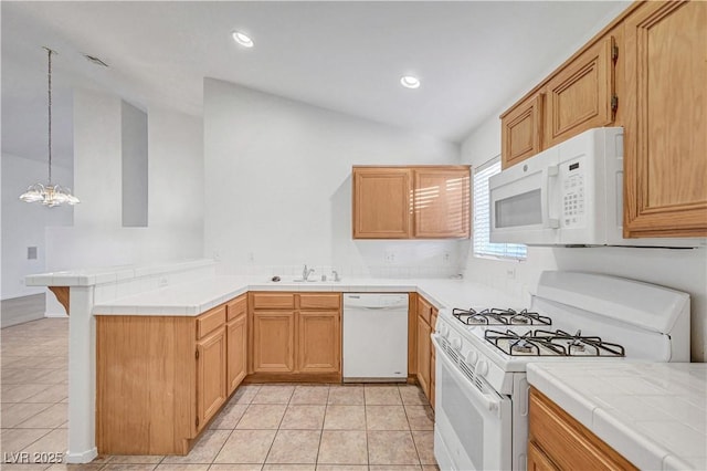 641 Bay Bridge Dr, North Las Vegas, NV 89032 - kitchen with white appliances, a peninsula, lofted ceiling, tile counters, and light tile patterned flooring