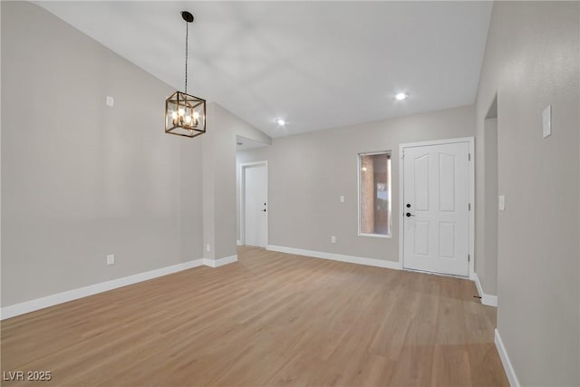 9513 Yucca Blossom Dr, Las Vegas, NV 89134 - empty room featuring light wood-style floors, a chandelier, vaulted ceiling, and recessed lighting