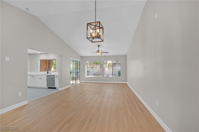 9513 Yucca Blossom Dr, Las Vegas, NV 89134 - unfurnished living room featuring a chandelier, lofted ceiling, light wood-type flooring, and a ceiling fan