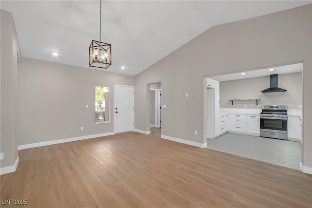 9513 Yucca Blossom Dr, Las Vegas, NV 89134 - unfurnished living room featuring lofted ceiling, light wood-type flooring, a chandelier, and recessed lighting