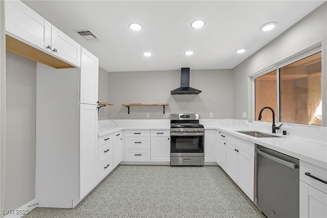 9513 Yucca Blossom Dr, Las Vegas, NV 89134 - kitchen with appliances with stainless steel finishes, wall chimney exhaust hood, open shelves, white cabinetry, and recessed lighting
