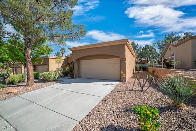 9513 Yucca Blossom Dr, Las Vegas, NV 89134 - view of front of house featuring stucco siding, concrete driveway, and an attached garage