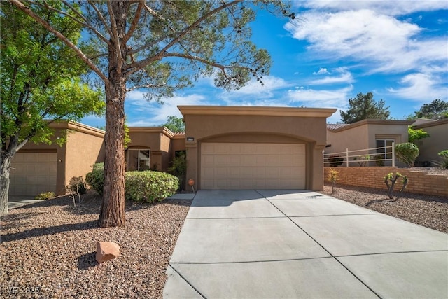 9513 Yucca Blossom Dr, Las Vegas, NV 89134 - pueblo-style house with stucco siding, concrete driveway, and an attached garage