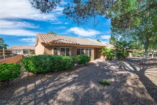 9513 Yucca Blossom Dr, Las Vegas, NV 89134 - back of house featuring a tiled roof and stucco siding