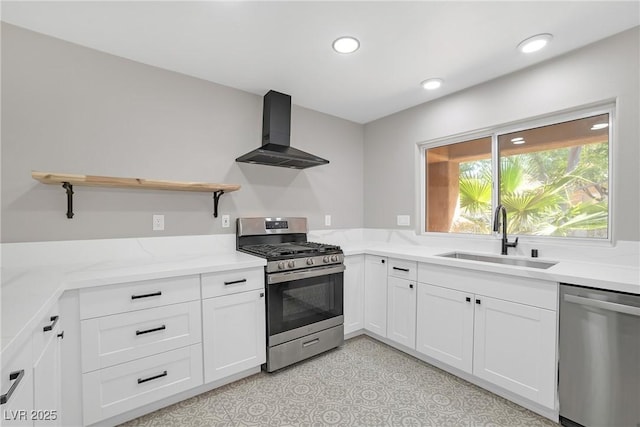 9513 Yucca Blossom Dr, Las Vegas, NV 89134 - kitchen with appliances with stainless steel finishes, wall chimney range hood, open shelves, white cabinets, and light stone countertops