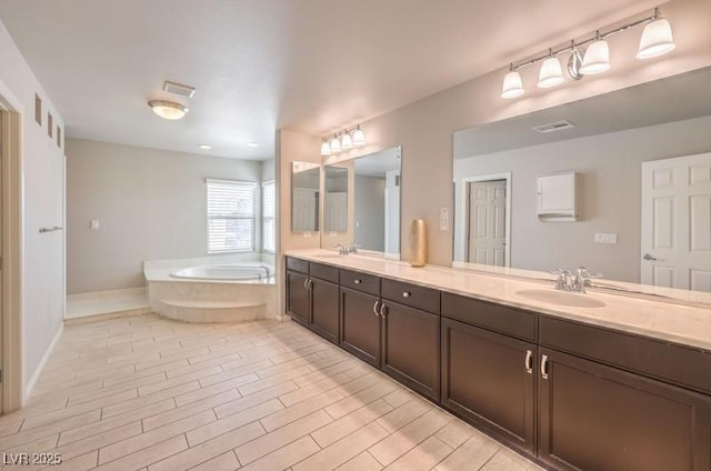 9876 Parador Cellars Ct, Las Vegas, NV 89141 - bathroom with a bath, double vanity, and wood finished floors