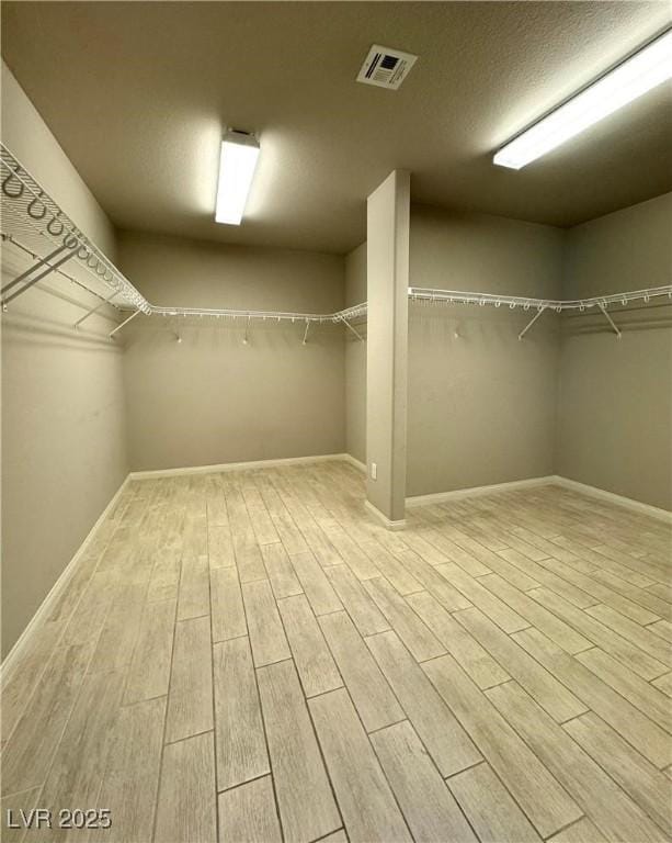 9876 Parador Cellars Ct, Las Vegas, NV 89141 - spacious closet featuring wood finished floors