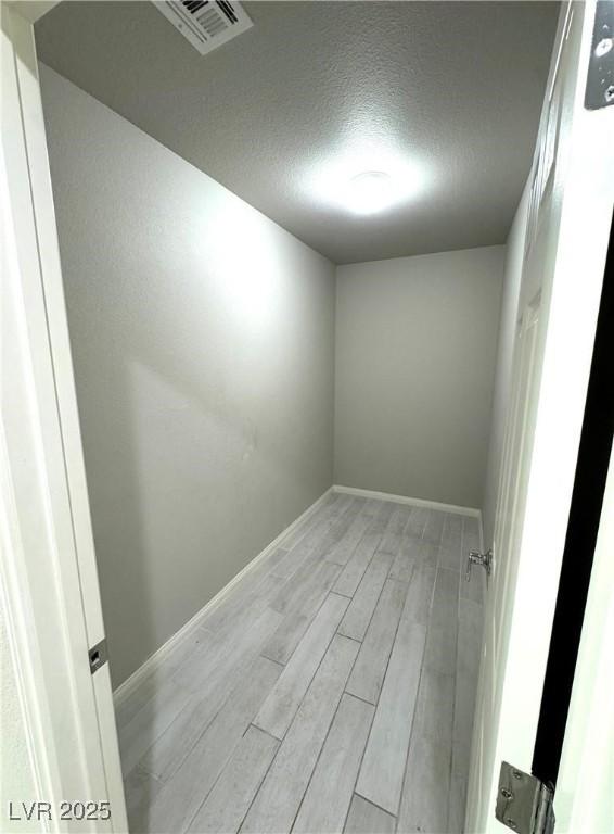 9876 Parador Cellars Ct, Las Vegas, NV 89141 - empty room with light wood-type flooring and a textured ceiling