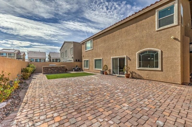 9876 Parador Cellars Ct, Las Vegas, NV 89141 - back of property featuring a fenced backyard, a patio, and stucco siding