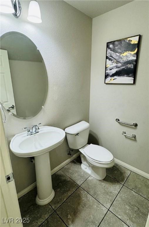 9876 Parador Cellars Ct, Las Vegas, NV 89141 - half bathroom with tile patterned floors