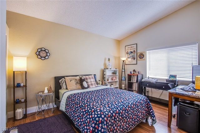 8324 Tide Pool Dr, Las Vegas, NV 89128 - bedroom featuring lofted ceiling, wood finished floors, and a textured ceiling