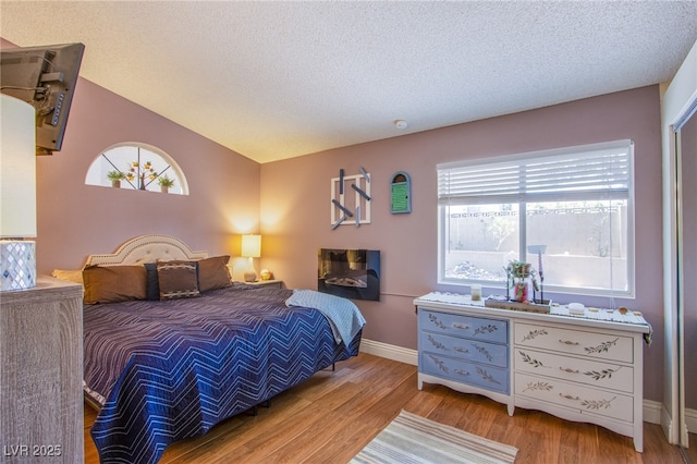 8324 Tide Pool Dr, Las Vegas, NV 89128 - bedroom with wood finished floors, a textured ceiling, and lofted ceiling