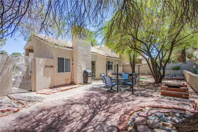 8324 Tide Pool Dr, Las Vegas, NV 89128 - fenced backyard featuring a patio area, a grill, and outdoor dining area