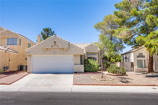 8324 Tide Pool Dr, Las Vegas, NV 89128 - view of front of property with concrete driveway, stucco siding, a garage, and a tiled roof