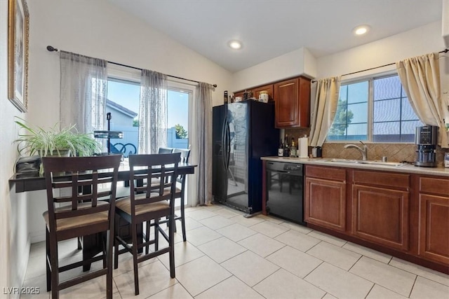 8550 Little Fox St, Las Vegas, NV 89123 - kitchen with black appliances, plenty of natural light, light countertops, vaulted ceiling, and light tile patterned floors