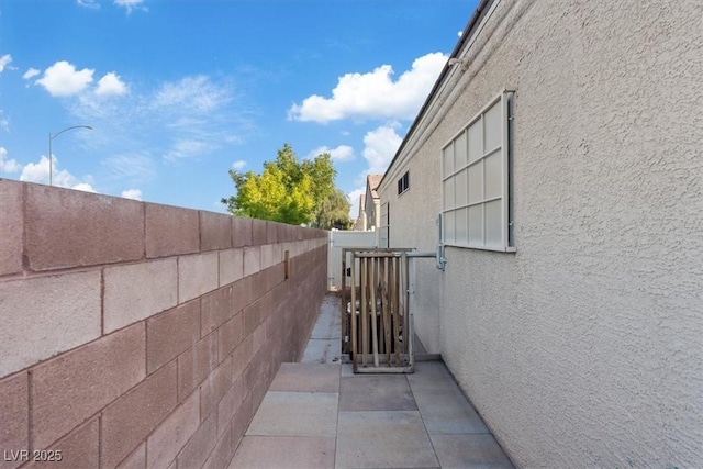 8550 Little Fox St, Las Vegas, NV 89123 - view of side of home featuring stucco siding and a gate