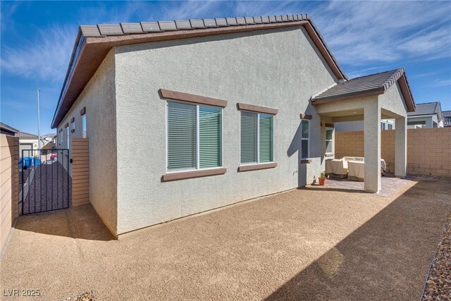 827 Klamath Springs St, Henderson, NV 89011 - rear view of property featuring stucco siding, a patio, and a gate