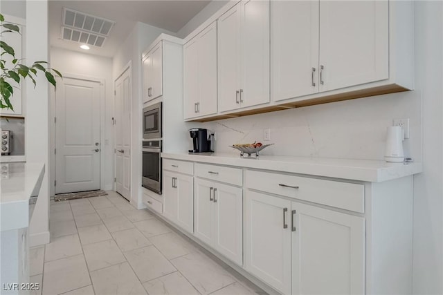827 Klamath Springs St, Henderson, NV 89011 - kitchen with appliances with stainless steel finishes, light marble finish floors, white cabinets, light countertops, and recessed lighting