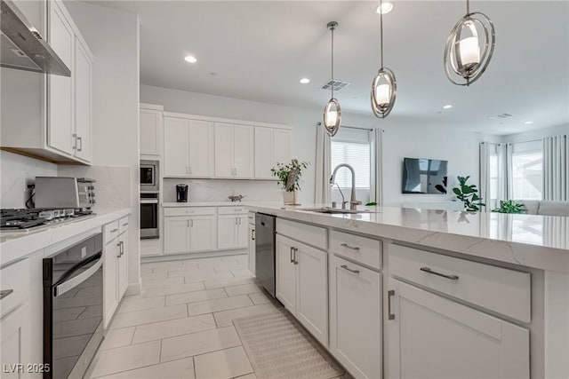 827 Klamath Springs St, Henderson, NV 89011 - kitchen featuring stainless steel appliances, ventilation hood, recessed lighting, backsplash, and white cabinets