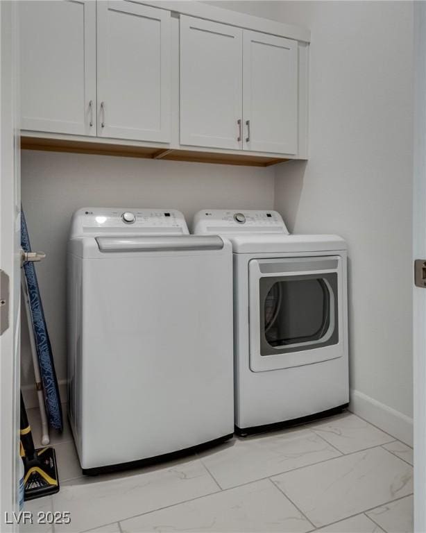 827 Klamath Springs St, Henderson, NV 89011 - washroom featuring washer and clothes dryer, cabinet space, and light marble finish flooring
