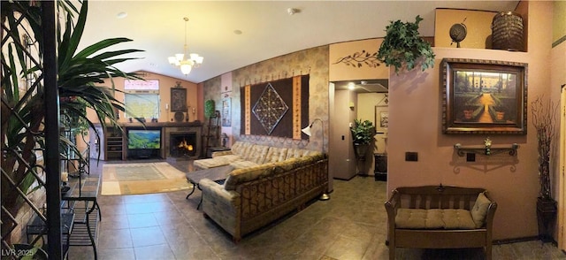 5929 Gentle Creek Ln, North Las Vegas, NV 89031 - living room featuring vaulted ceiling, tile patterned flooring, a chandelier, and a lit fireplace