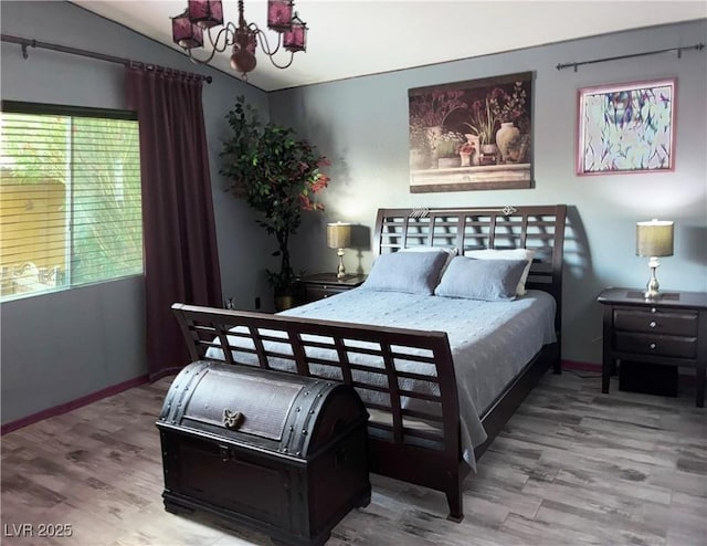 5929 Gentle Creek Ln, North Las Vegas, NV 89031 - bedroom with a chandelier, wood finished floors, and vaulted ceiling