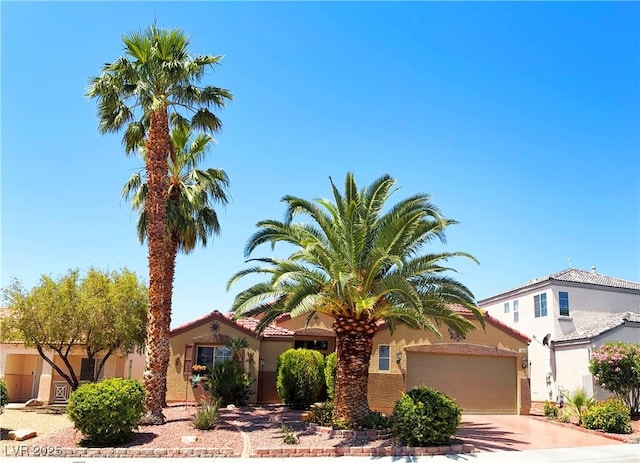 5929 Gentle Creek Ln, North Las Vegas, NV 89031 - mediterranean / spanish-style house with concrete driveway, stucco siding, and an attached garage