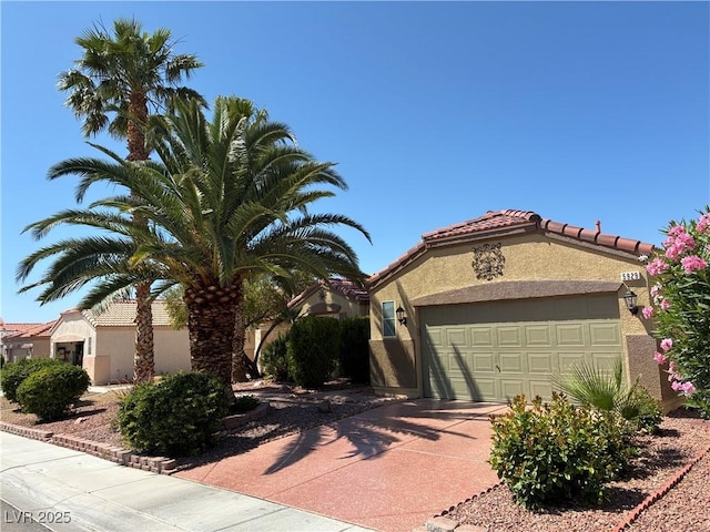 5929 Gentle Creek Ln, North Las Vegas, NV 89031 - mediterranean / spanish-style house with concrete driveway, stucco siding, an attached garage, and a tiled roof