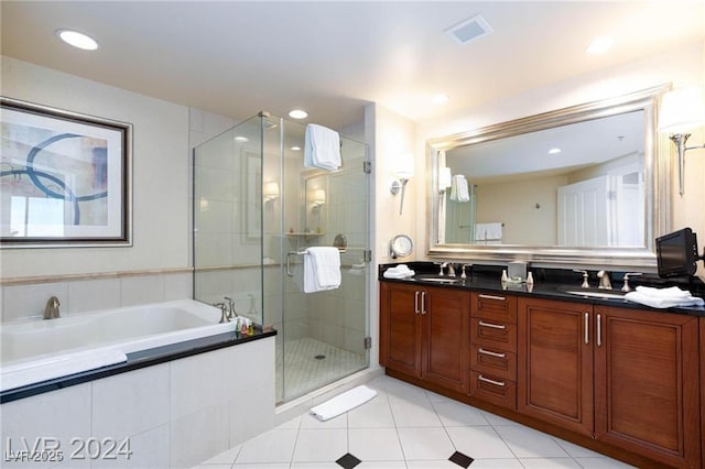 135 E Harmon Ave Unit 2116, Las Vegas, NV 89109 - full bathroom featuring double vanity, a garden tub, a stall shower, tile patterned flooring, and recessed lighting