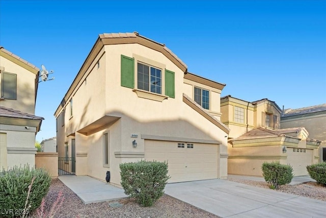 6460 Raven Hall St, North Las Vegas, NV 89084 - view of front of house with stucco siding, concrete driveway, a gate, and a garage