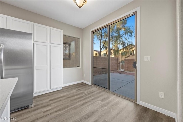 6460 Raven Hall St, North Las Vegas, NV 89084 - unfurnished dining area with light wood-type flooring and baseboards