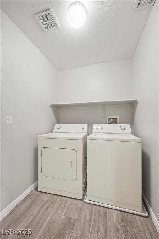 6460 Raven Hall St, North Las Vegas, NV 89084 - laundry area with washer and clothes dryer and wood finished floors