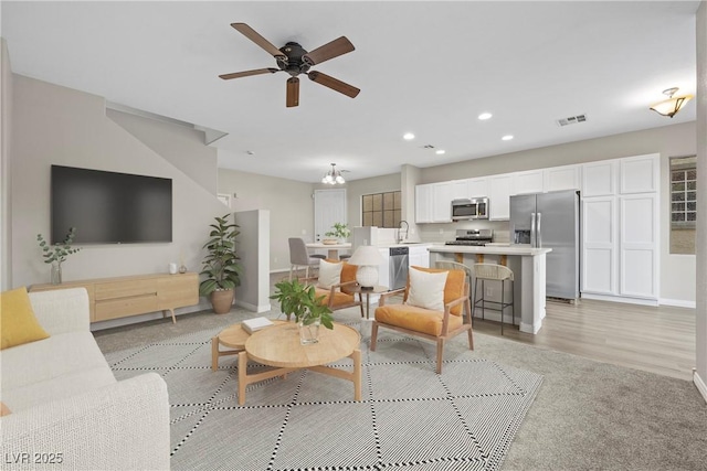 6460 Raven Hall St, North Las Vegas, NV 89084 - living room with recessed lighting, ceiling fan, and a chandelier