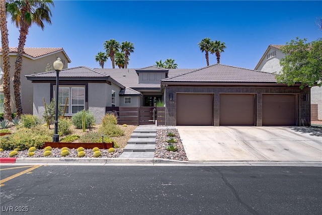 1509 Winslow St, Las Vegas, NV 89117 - view of front of property with an attached garage, driveway, a tile roof, and stucco siding