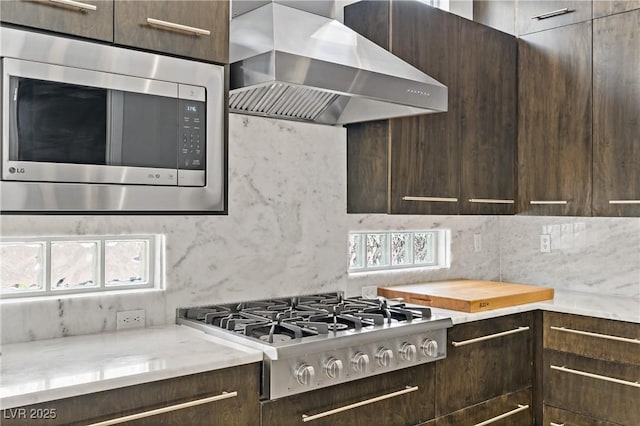 1509 Winslow St, Las Vegas, NV 89117 - kitchen featuring appliances with stainless steel finishes, wall chimney exhaust hood, and dark brown cabinetry