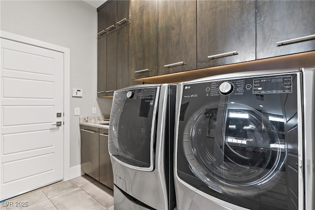 1509 Winslow St, Las Vegas, NV 89117 - laundry room featuring cabinet space, washing machine and clothes dryer, and light tile patterned floors