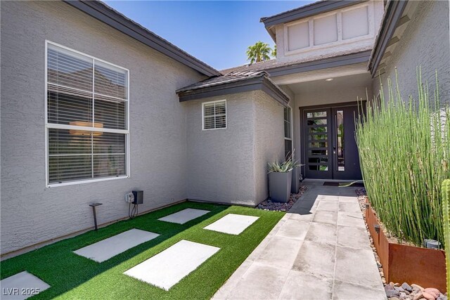 1509 Winslow St, Las Vegas, NV 89117 - property entrance featuring french doors, stucco siding, and a lawn