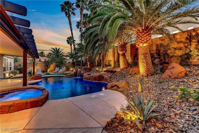 1509 Winslow St, Las Vegas, NV 89117 - pool at dusk featuring a patio area and a pool with connected hot tub
