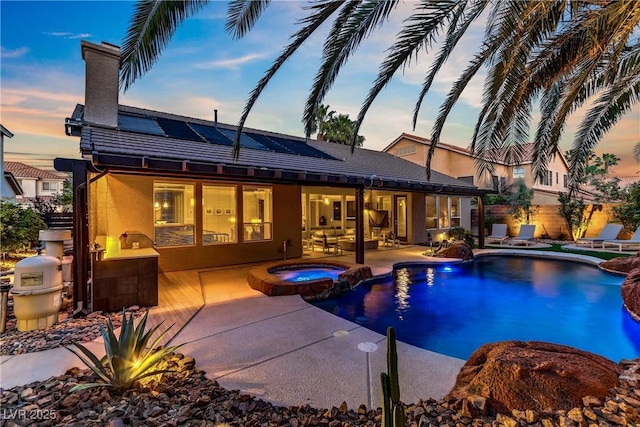 1509 Winslow St, Las Vegas, NV 89117 - pool at dusk featuring a patio area and a pool with connected hot tub
