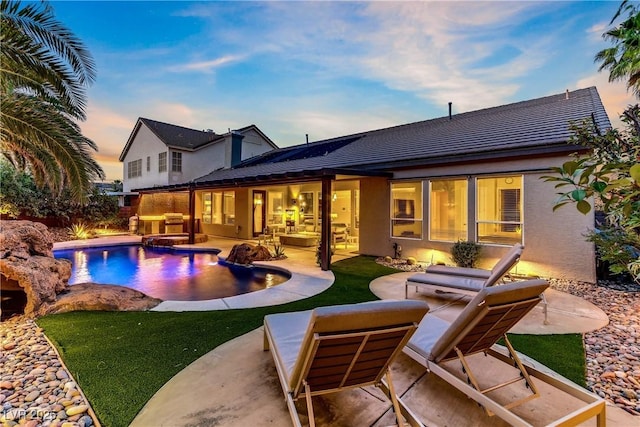 1509 Winslow St, Las Vegas, NV 89117 - rear view of house with a patio area, an outdoor pool, outdoor lounge area, and stucco siding