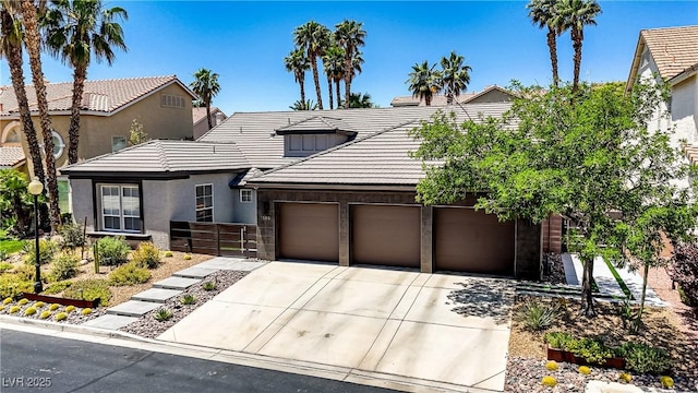 1509 Winslow St, Las Vegas, NV 89117 - traditional-style home with concrete driveway, an attached garage, a tile roof, and stucco siding